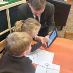 teacher and children using ipad